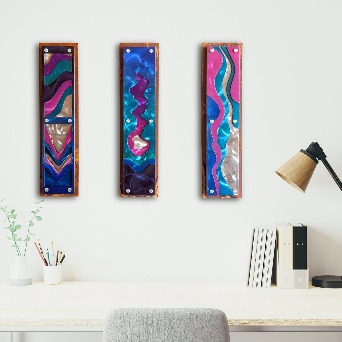 Home office mockup: Confluence, three candy-painted steel wave panels, hanging in a home office.