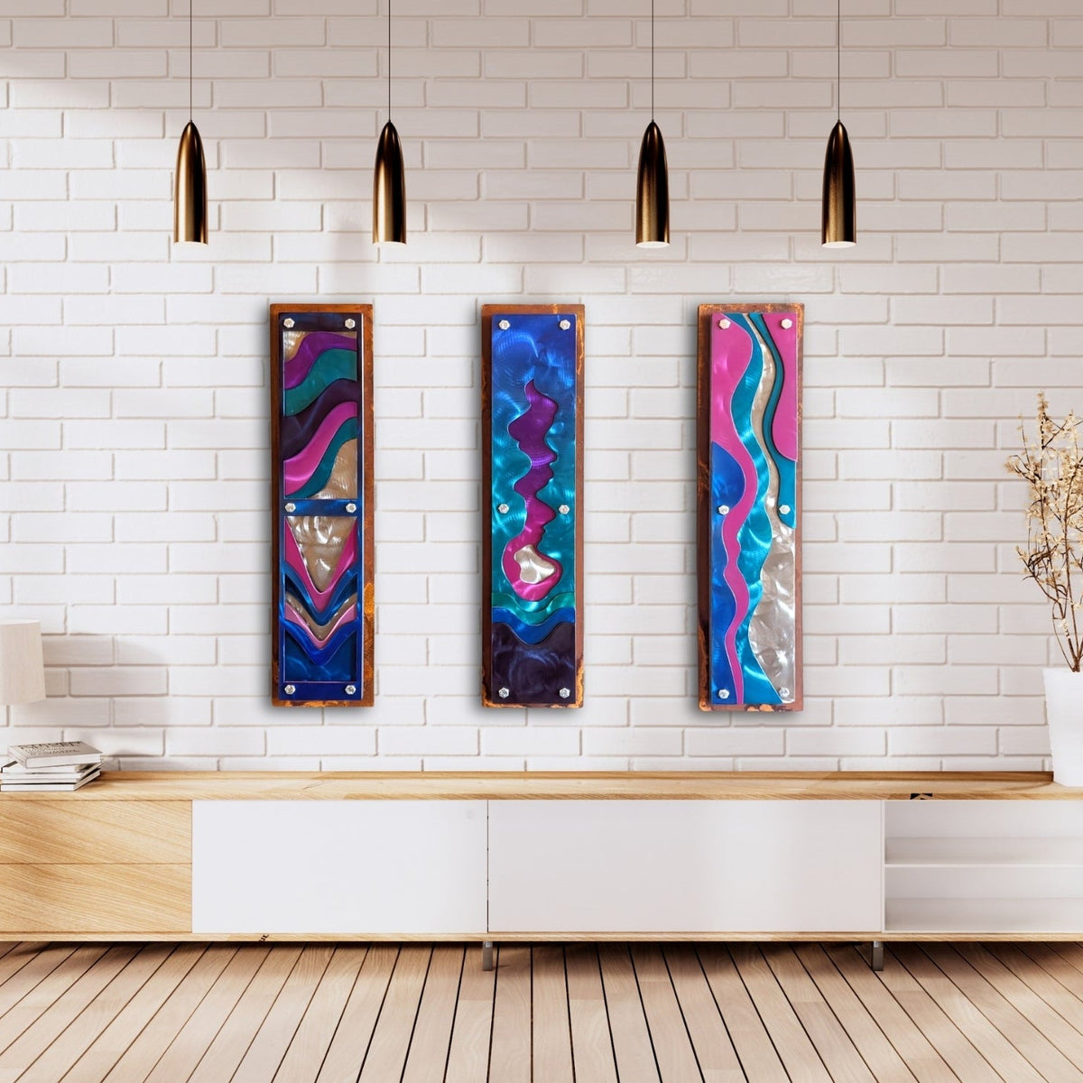White brick living room mockup: Confluence layered steel water wall art, a set of three panels, displayed on a white brick wall in a living room.