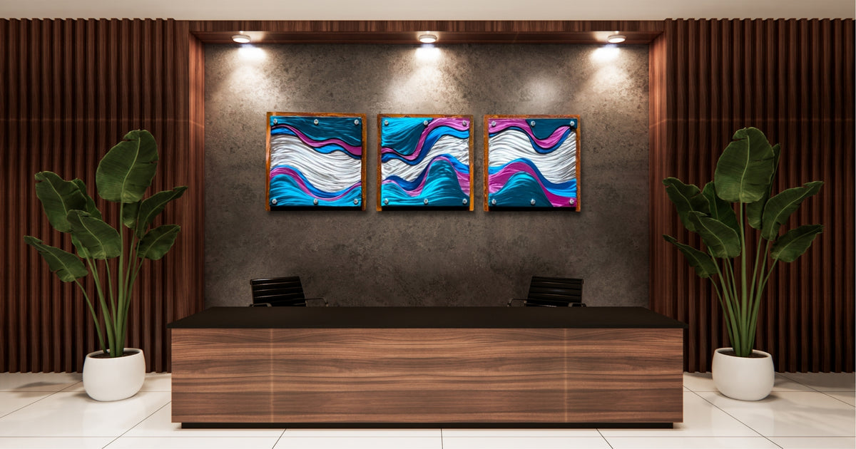 Three layered steel wave panels lit by spotlights on a dark wall behind a wood reception desk.