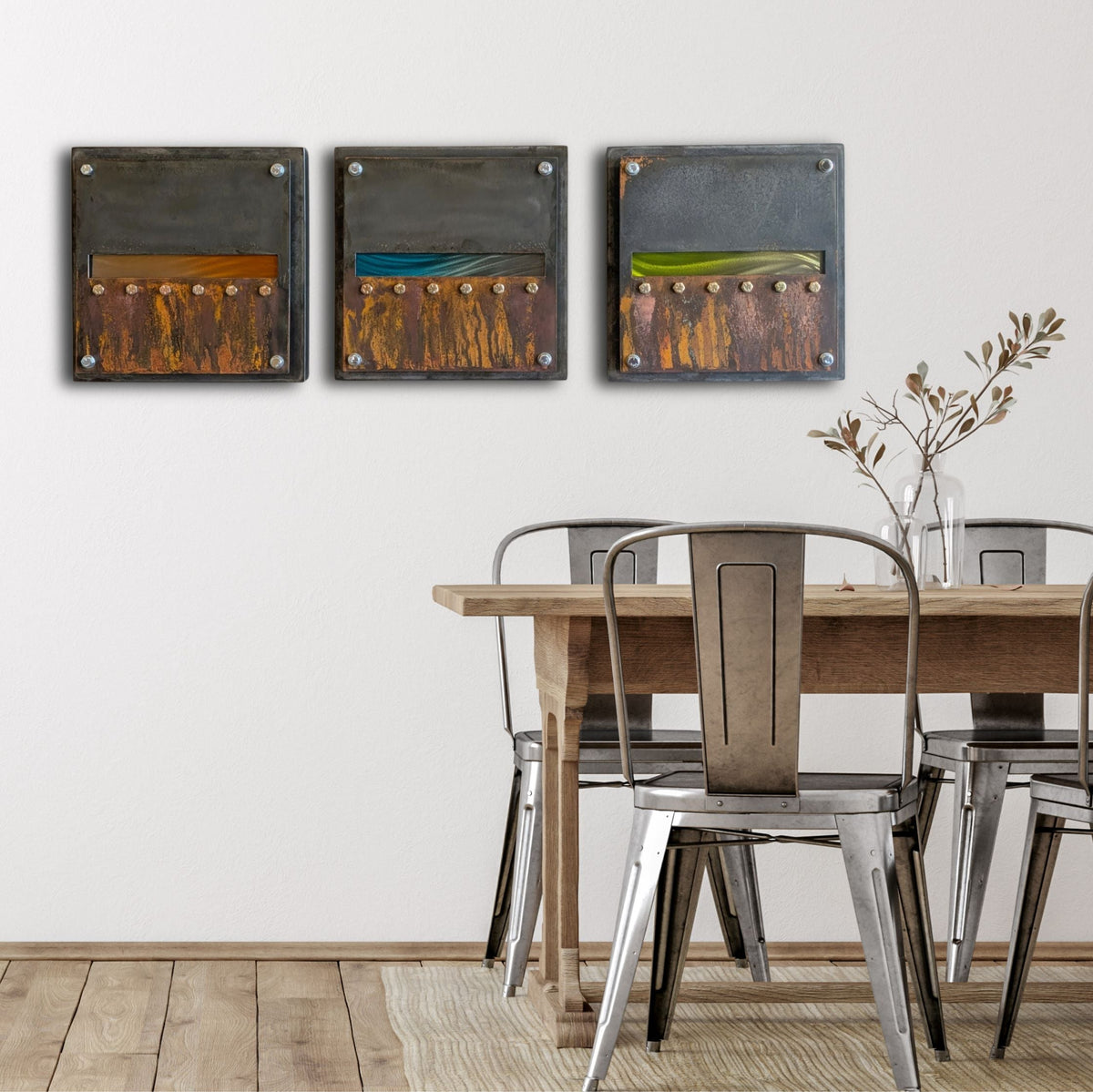 Edge of Day hanging in a row above a rustic wood dining table with metal chairs.